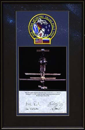 1995 STS-063 FLOWN MISSION PATCH: Flown during first MIR rendezvous mission for shuttle, patch is mounted on special glass front framed display bearing signatures of shuttle crew. Overall size about 18x12". "