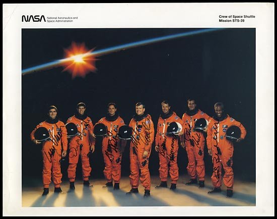 1991 STS-039 CREW SIGNED PHOTO: Original NASA issued 8"x10" color litho signed in black sharpie by Astronauts Coats, McMonagle, Bluford, Harbaugh, Hammond, Hieb & the late Lacy Veatch. Great uninscribed photo in good condition.