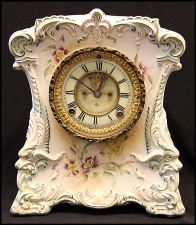 c.1882 ANSONIA MANTLE CLOCK ROYAL BONN CHINA: Lovely Ansonia mantle clock of Royal Bonn China, with beautiful multicolor floral design. Patented 1882. Includes pendulum, missing back cover. 11¾ tall, 9 lbs. Some toning on front otherwise very ni