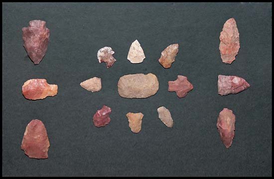 c.1600s INDIAN BIRDPOINTS, DRILLS, ARROWHEADS: Nice set of 15 red colored points with scraper in the middle from the Cahokia Indians of Southwestern Illinois, artfully arranged and framed in 12x15" glass case on dark green background.