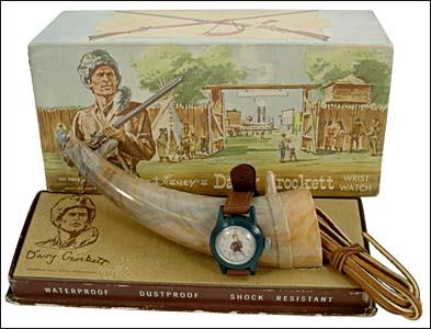 DAVY CROCKETT WRIST WATCH WITH POWDERHORN: c.1955/Colorful 3x3½"x7½" wide illustrated display box holding wrist watch positioned on replica powder horn. Watch functional, very fine; box with minor corner wear to base, otherwise very fine.