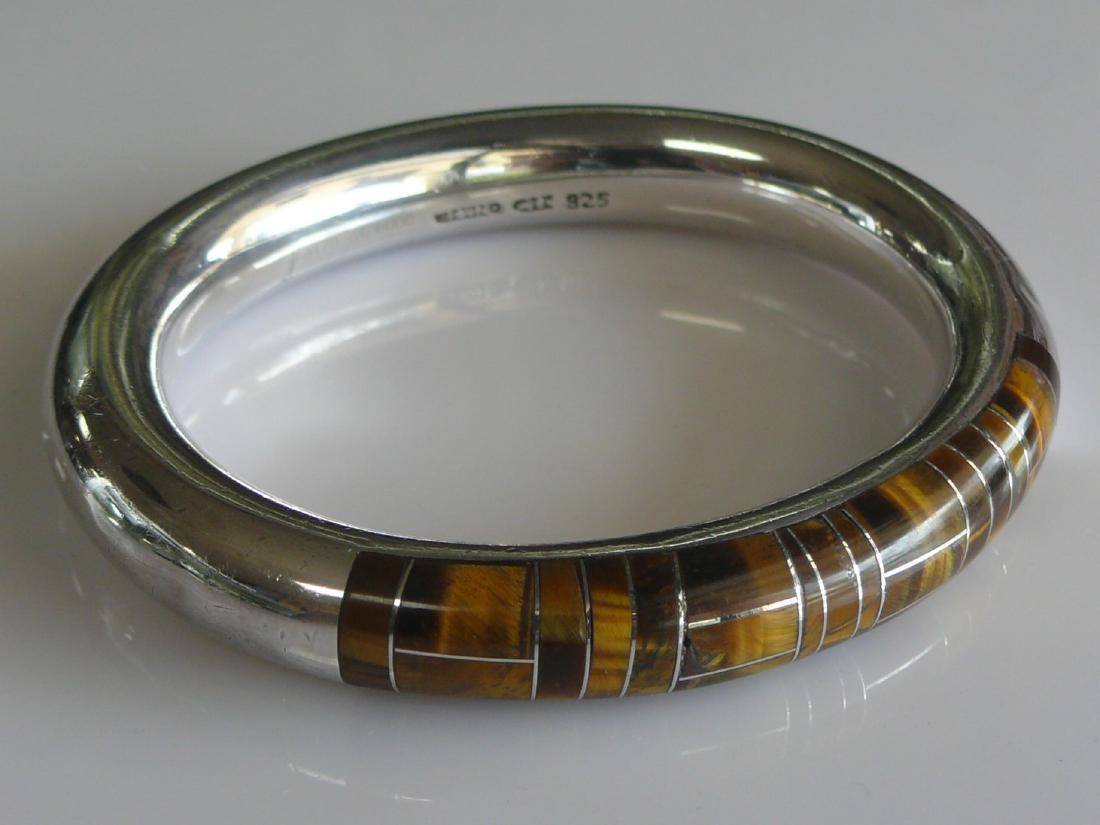Roberto Salazar Sterling Taxco Bangle: Very rare and collectible Taxco bold bangle bracelet set with tigers eye. Piece was designed by artisan Roberto Salazar and is signed/numbered 0170/6000. Weight: 64 Grams Condition: Lightly Worn