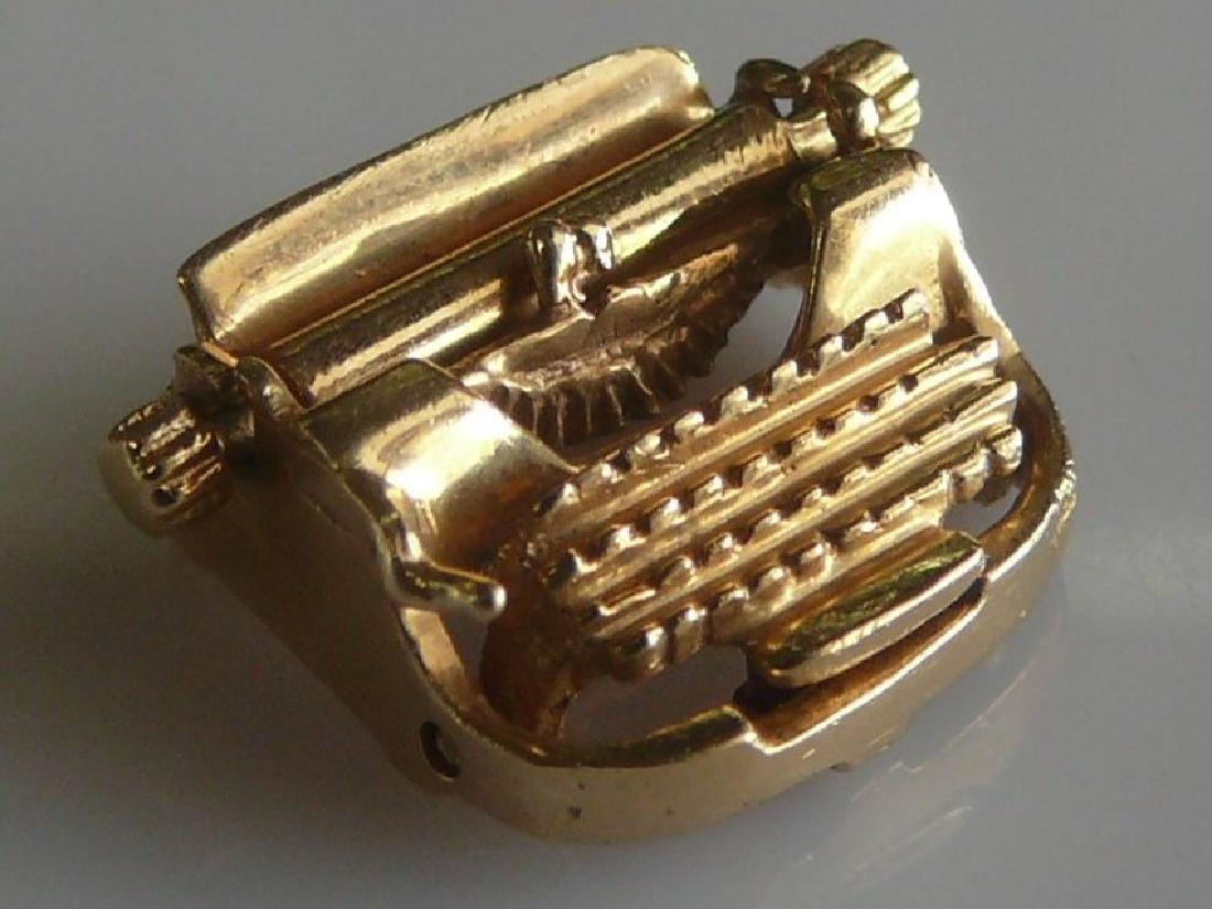 14k Typewriter Charm: 14k yellow gold ladies typewriter charm. Features moving parts - including keytop and platen. Type: Antique Charm Material: 14k Gold Stone Weight: apx 2cts Side Stone C