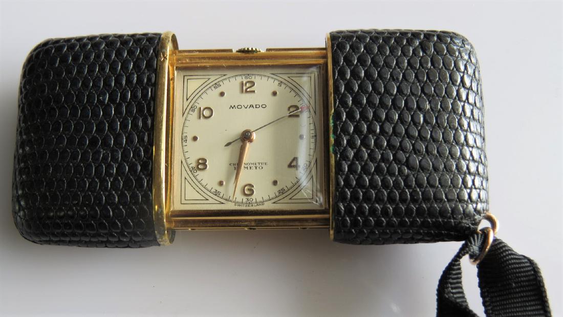 Movado Ermeto Purse Watch: Vintage Movado Ermeto purse watch. Black lizard. Working. Swiss made. Model 1253 877M. Circa 1950. 32mm height - 41mm width unopened - 70mm width opened - 11mm depth. 24mm watch face. 50.2 DWT. Workin