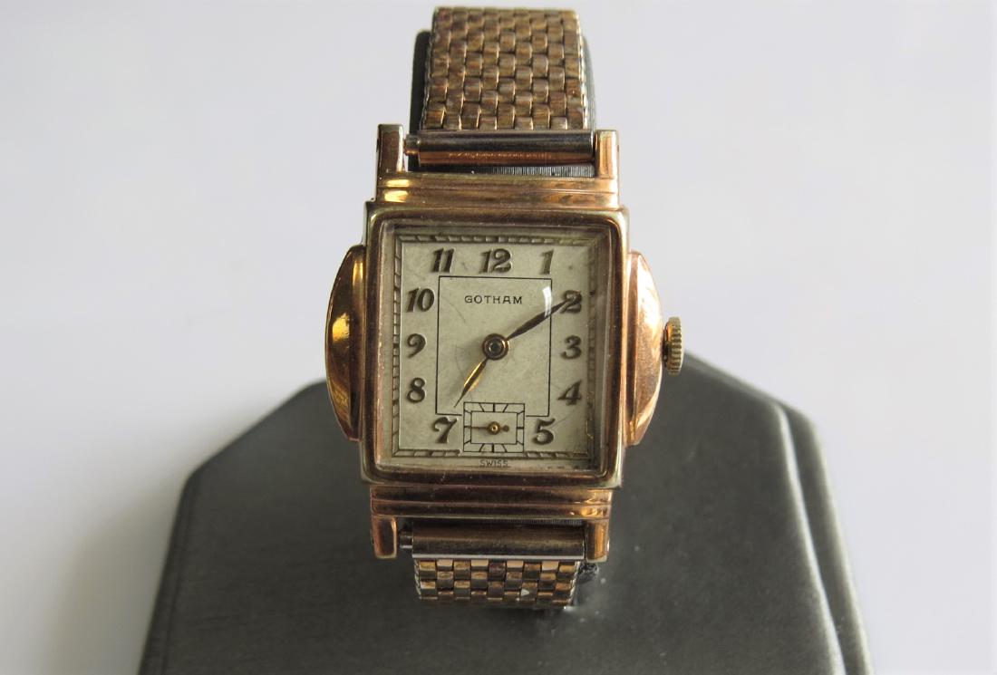 Vintage Gotham 10K Gold Watch: Vintage Gotham 10K yellow gold plated wrist watch with stainless steel back. Square style face. Net link band with clamp closure. Swiss made. Engraved -B.J G.J 12-25-41- on the back. Circa 1941. 25mm 