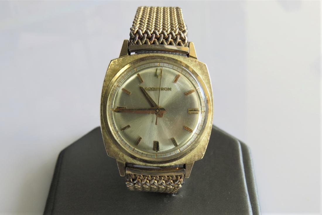 Bulova Accutron 10K Gold Vintage Watch: 10K gold filled bezel Bulova Accutron wrist watch with stainless steel net chain band. Circa 1967. 30mm case. 14mm band width. Serial number D21269. 42.3 DWT. Working.