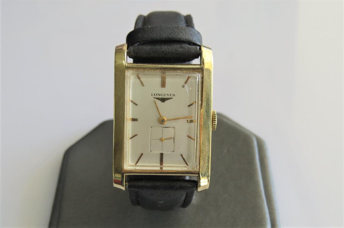 Vintage 14K Gold Longines Watch: Mens vintage 14K yellow gold Longines wrist watch. Rectangle case. Black genuine pigskin band by Hadley-Roma with 7 adjustable wrist sizes. 22mm case. 15mm band width. 17.6 DWT. Circa 1950s. Working.