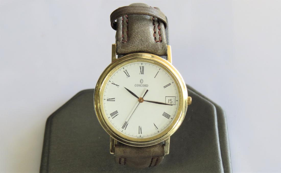 Vintage Concord 14K Yellow Gold Watch: Vintage Concord 14K yellow gold mens wrist watch with tan genuine leather band. Roman numeral hour markers. 25mm case. 14mm band width. 6 adjustable wrist sizes. Water resistant. Not running. 2278222 