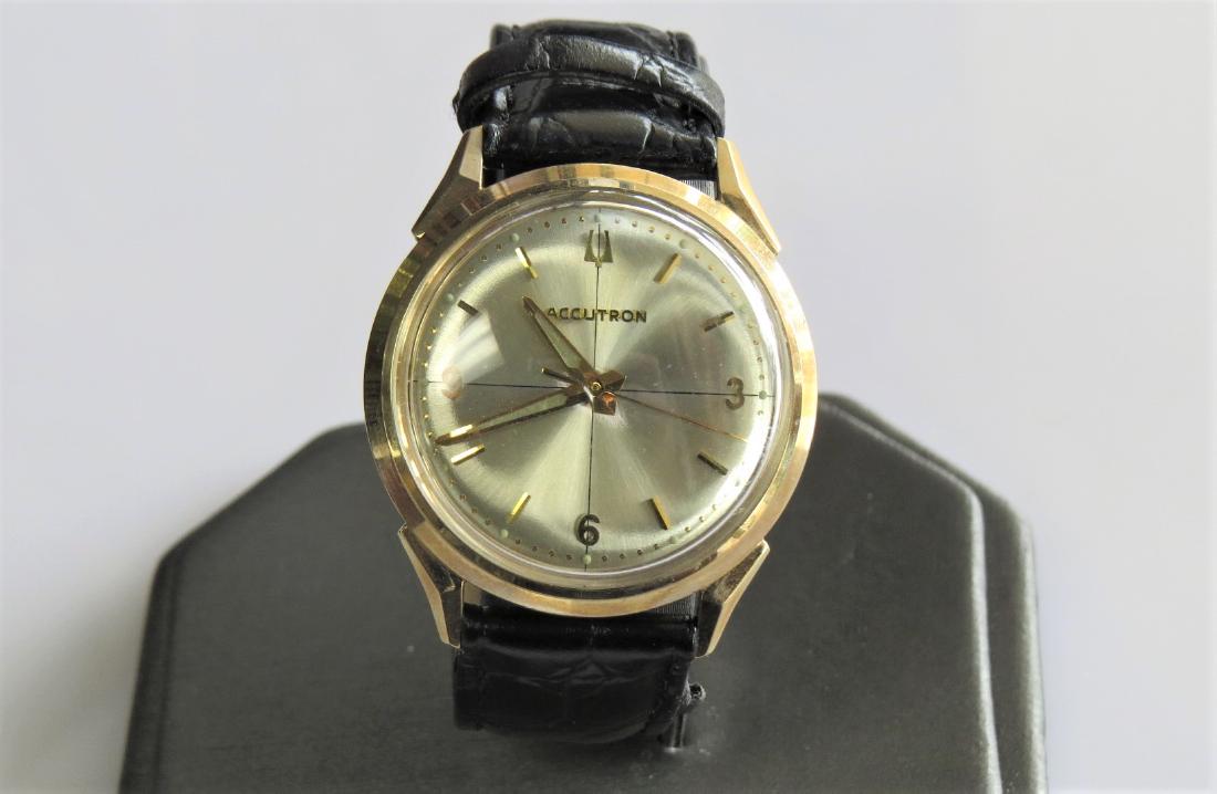 Bulova Accutron Vintage Watch: Vintage Bulova Accutron mens wrist watch. Black genuine leather band with 7 adjustable wrist sizes. 10K yellow gold filled bezel. B90990 Circa 1967. 26 mm face. 24.4 DWT. Working.