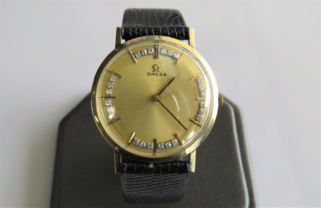 Vintage Omega Watch with Diamond Hour Markers: Vintage 14K Yellow Gold stamped Omega mens wrist watch with .05 diamond hour markers. 24 DIA total. Black genuine leather band with 6 adjustable wrist sizes. 26 mm face. 15.0 dwt. D6672. 456962. Worki