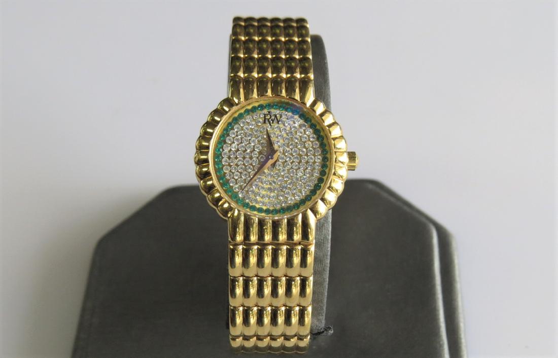 Raymond Weil 18K Gold and Diamond Watch: Ladies Raymond Weil wrist watch 18K yellow gold electroplated. Green and white diamond face. Model 4705-2. 22mm case. 11mm band width. 2.2- diameter wrist band. 6 jewel. 41.4 DWT. Working.