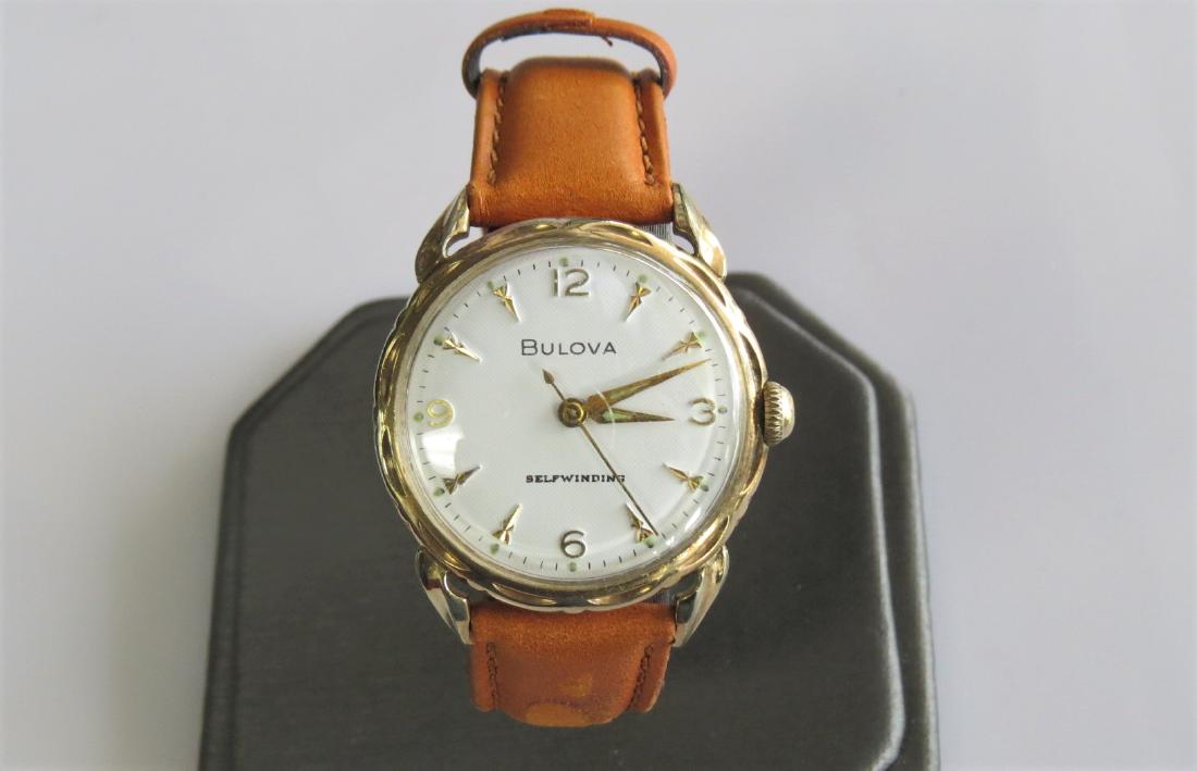 Vintage Bulova Wrist Watch: 10K yellow gold rolled plate. Bulova unisex watch with genuine leather band. 7 adjustable wrist sizes. Self winding. D347065. Circa 1959. 24.2 dwt. Working.