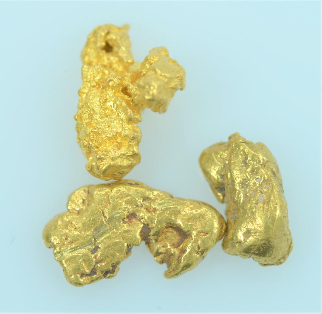 Gold Nuggets: Three 20.5K - 22K purity gold nuggets weighing 1.4 grams.