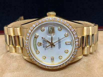 Gold Rolex Watch: Rolex wrist watch. Working. With box and papers. 18038. White Mother of Pearl dial with diamond bezel. 36mm case.