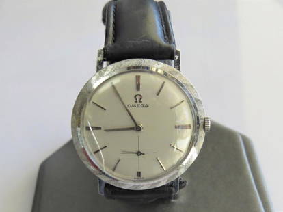 Vintage 14K White Gold Omega Watch: Vintage 14K white gold Omega men's wrist watch with genuine leather black band. 7 adjustable wrist sizes. 25mm face. 19.7 dwt. 17 jewels. Circa 1965. Cracked glass.