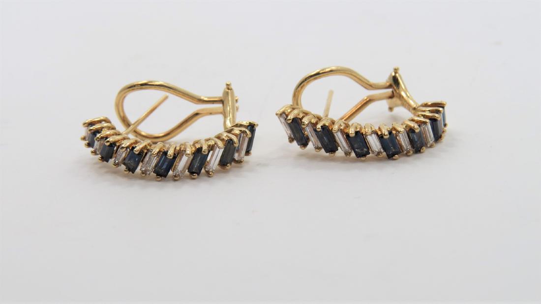 Diamond and Sapphire Earrings: Beautiful 14K yellow gold diamond and sapphire baguette hoop earrings. Earrings measure 22.4mm x 14mm oval shape with omega clip backs. Each earring has 0.35 CT sapphires and 0.35 CT total diamond wei