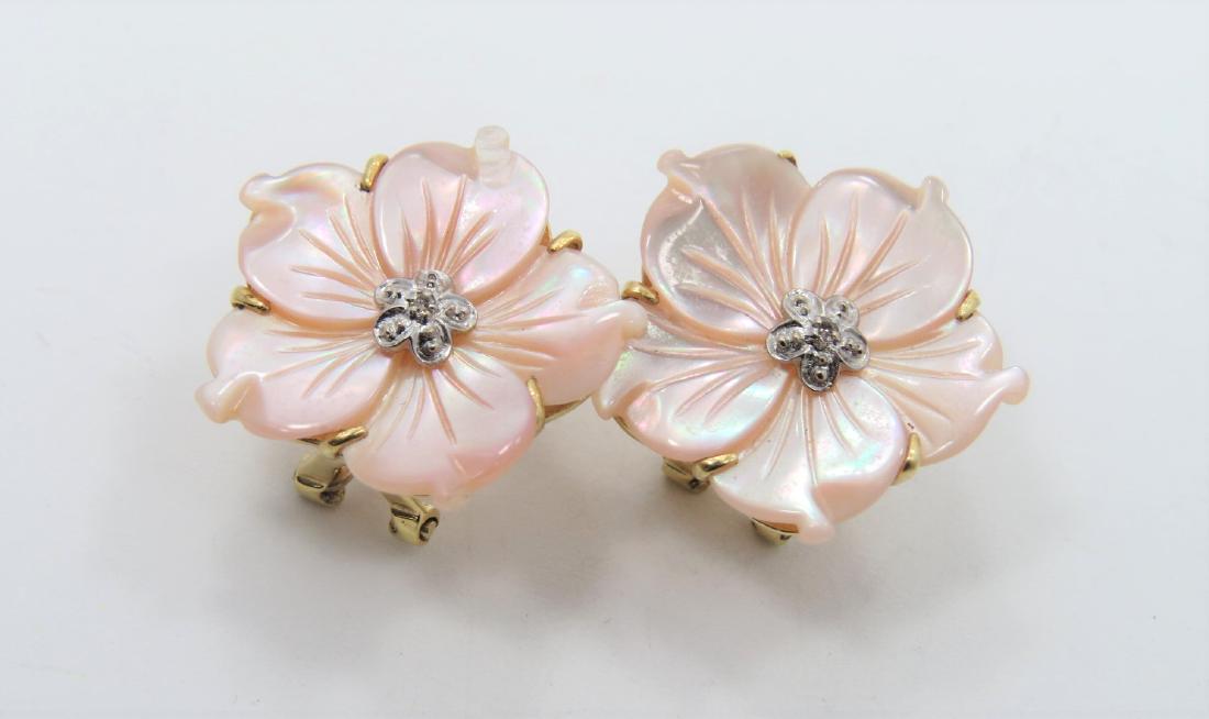 Pearl Flower Earrings: Lovely Mother of Pearl flower shaped earrings set in 14k yellow gold with omega clip backs. Center has one 0.01 carat diamond on each earring, set in white gold. Earrings measure 21.2mm. 4.6 grams tot