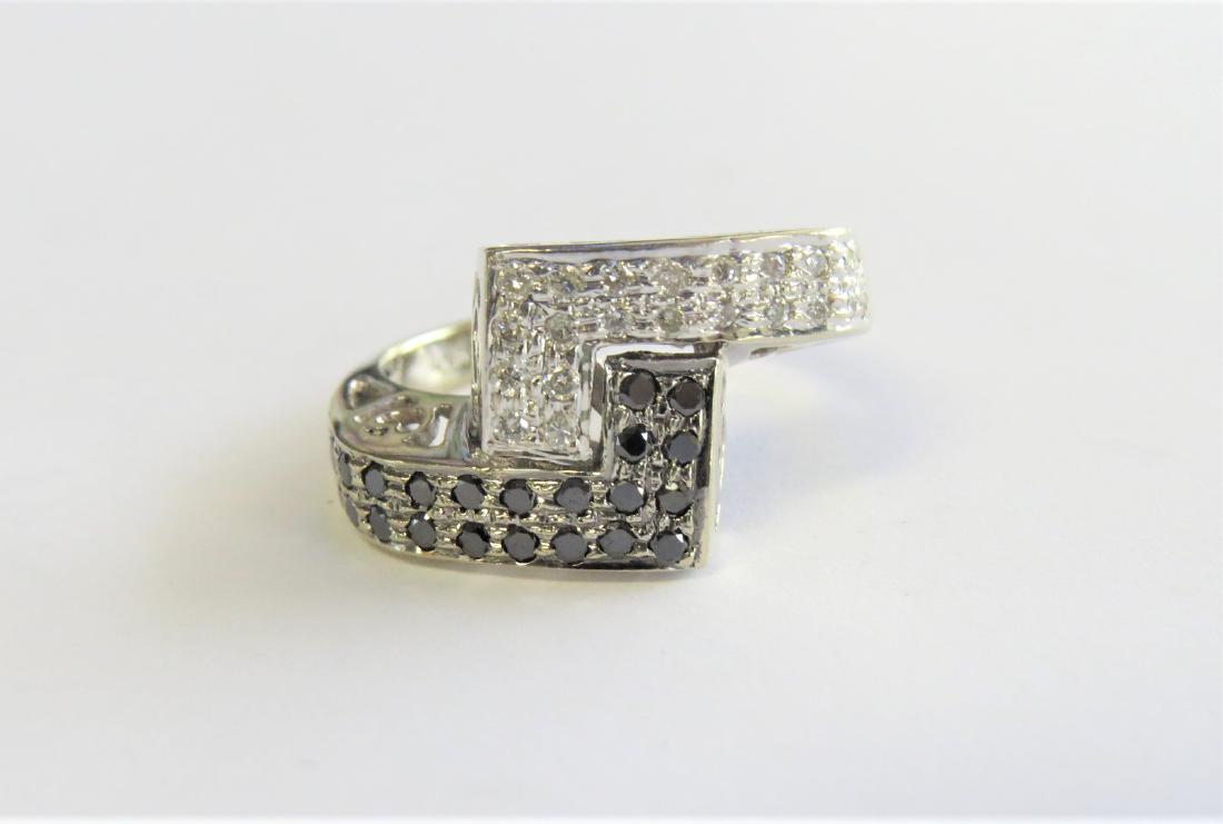 Black and White Diamond Bypass Ring: 14k white gold ring with black and white diamonds. Approximately 0.50ct total diamond weight. There are hearts hand-cut into the gallery - making this ring ideal for that special someone. This piece i