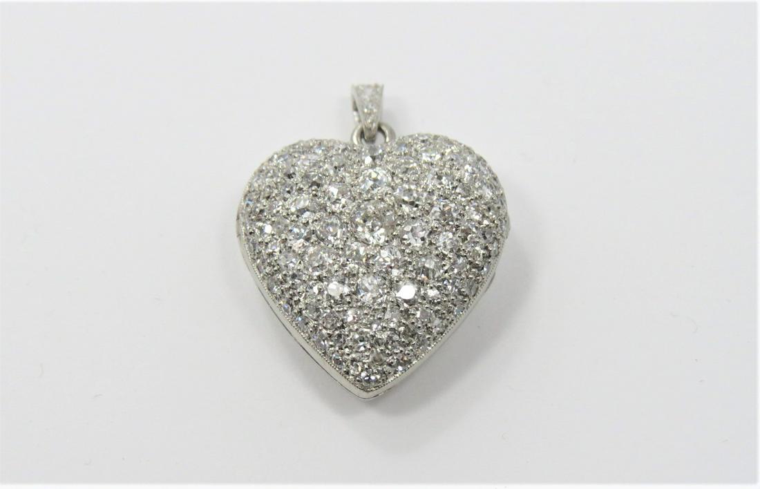 Platinum and Diamond Heart Locket: Gorgeous platinum and diamond pave heart locket. Approximately 3.00 CT total diamond weight. Matching standard bail with diamonds. 1.25" x 0.75" x 10mm. 8 grams total weight.