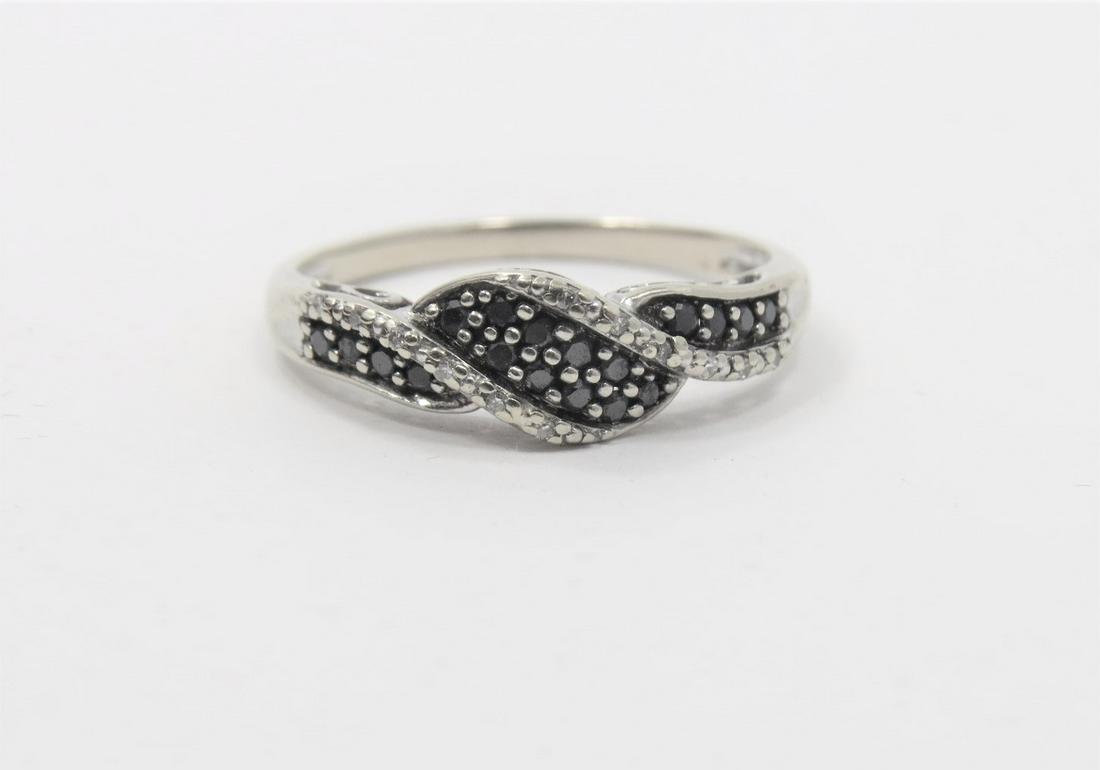 14K White Gold Black and White Diamond Ring: Stamped and tested 14K white gold black and white diamond ring in a twist design. Beautiful filigree gallery. Approximately 0.25 ct total diamond weight in round full cut diamonds. Size 7.5.