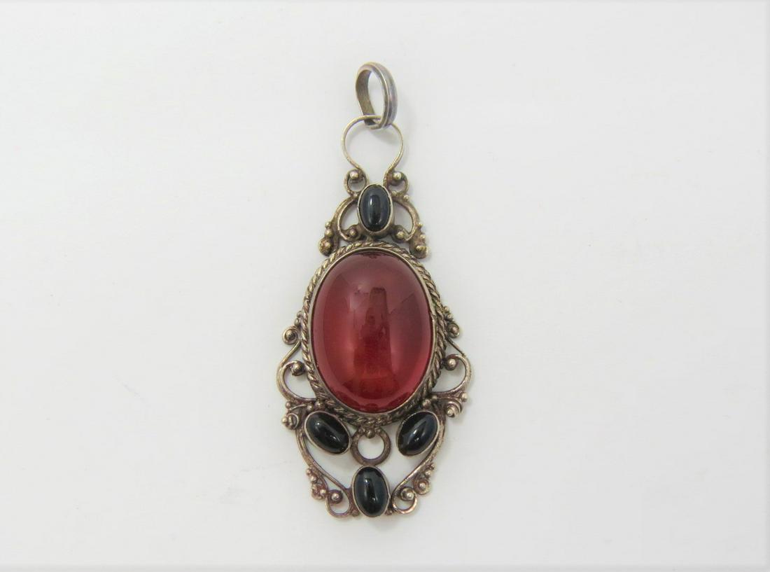 Sterling Silver Estate Pendant: Unique sterling silver estate pendant with a filigree design. Set with black onyx and carnelian cabochon. This gorgeous vintage piece weighs 9.7g and measures 48.7mm x 23.2mm