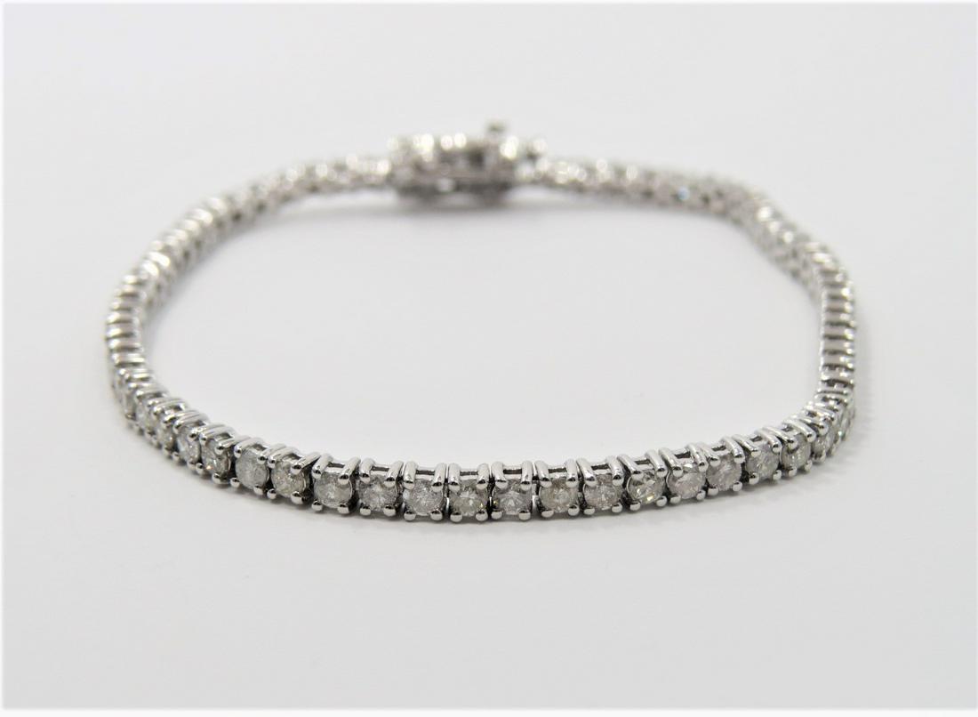 Certified and Appraised Diamond Tennis Bracelet: Certified and appraised for $7,286! Tested 14K white gold diamond tennis bracelet mounted with sixty-eight round brilliant cut diamonds weighing approximately 3.24 carats. Measures 7.25 inches. Tensio