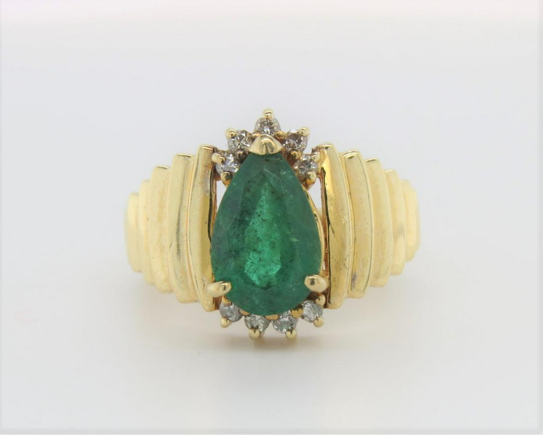 14K Yellow Gold Vintage Emerald & Diamond Ring: Stamped 14K yellow gold vintage emerald and diamond ring. Approximately 1.5 ct center pear shaped emerald. Approximately 0.05 ct total diamond weight in eight round diamonds accenting the top and bott