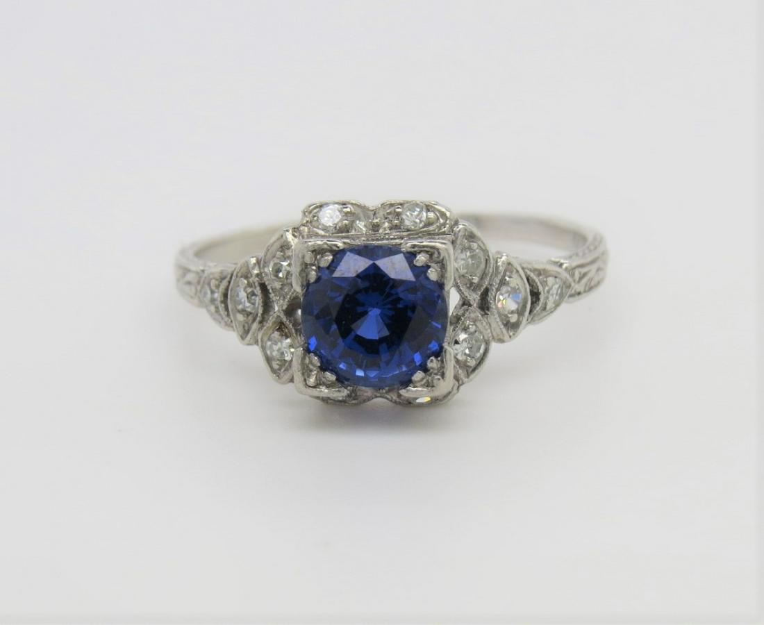 Platinum, Sapphire and Diamond Ring: Platinum, lab sapphire and diamond Edwardian etched ring set with twelve single cut round. diamonds. 6mm, round 1.05 ct sapphire. Ring size 7.5. Weighs 3.6 grams.