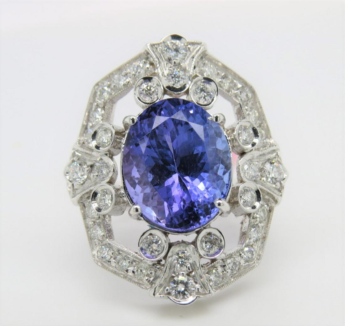 Certified 14K White Gold Tanzanite & Diamond Ring: Certified and appraised for $12,600.00! Stamped 14K white gold, tanzanite and diamond milgrain adorned art deco style ring. Center featured oval tanzanite is set with four prongs and weighs approximat