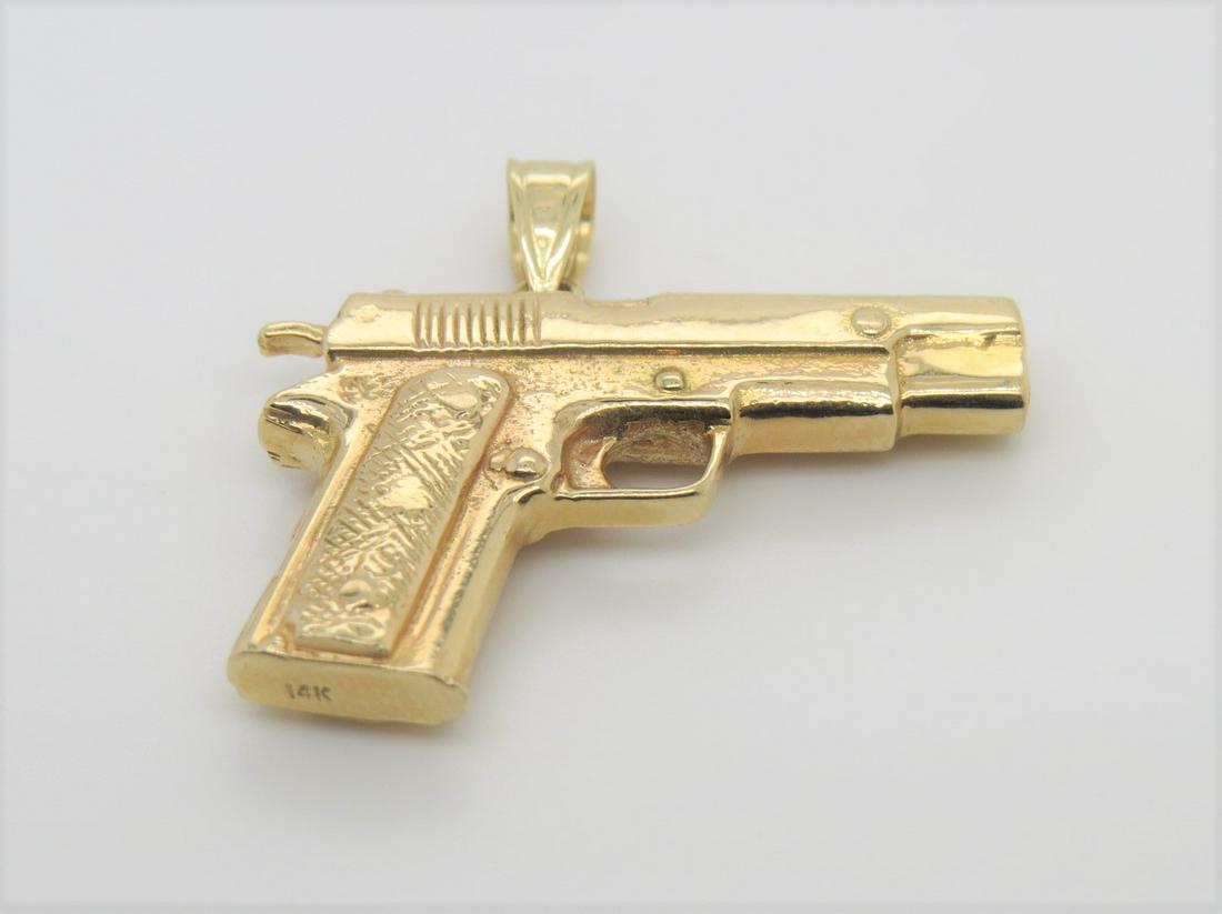 14K Yellow Gold Colt 1911 Pistol Gun Pendant: Stamped 14K yellow gold very nice, intricately detailed Colt 1911 pistol firearm pendant. Measures 1.1" x 19mm. Heavy weight of 13.3 grams.