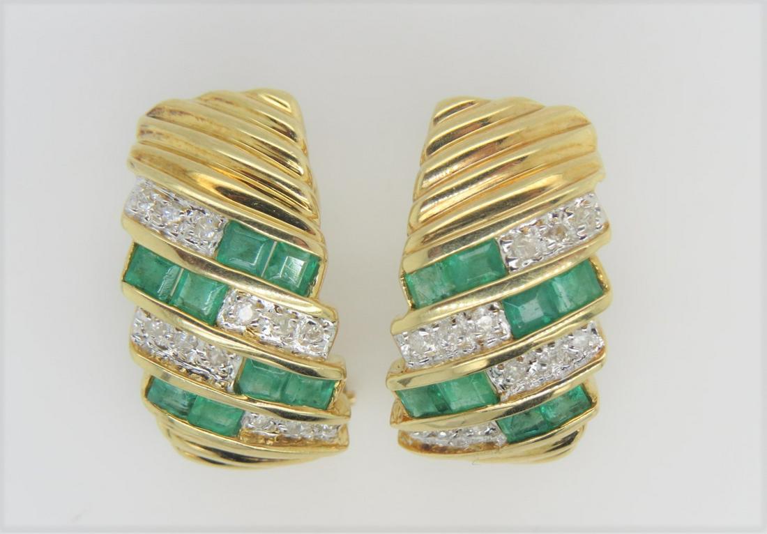 14K Yellow Gold Diamond Emerald Half Hoop Earrings: Stamped 14K yellow gold, diamond and emerald half hoop earrings. Omega backs. Approximately 1.92 ct square cut Colombian emeralds, 0.12 ct total diamond weight. 20 mm x 10 mm. 7.6 grams.