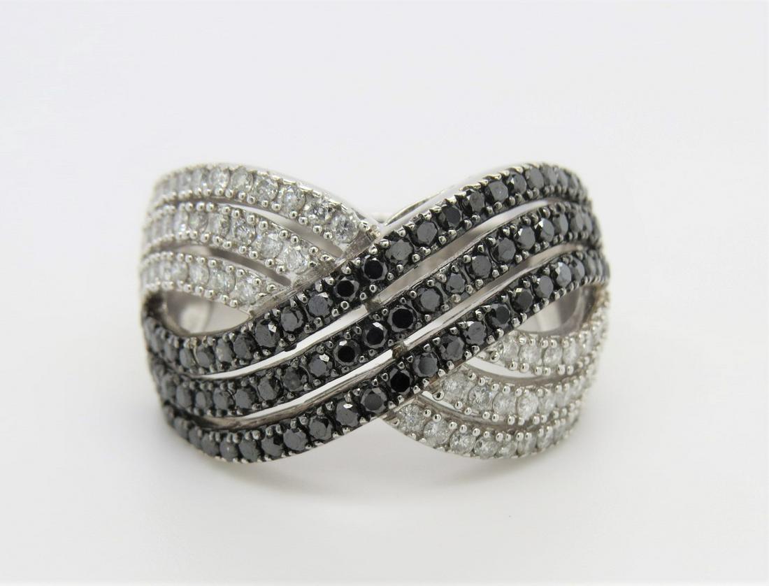 14K White Gold Black and White Diamond Ring: Stamped 14K white gold, Black and white diamond bypass style ring. Size 7. Approximately 1.30 total diamond weight. 10.1 grams.