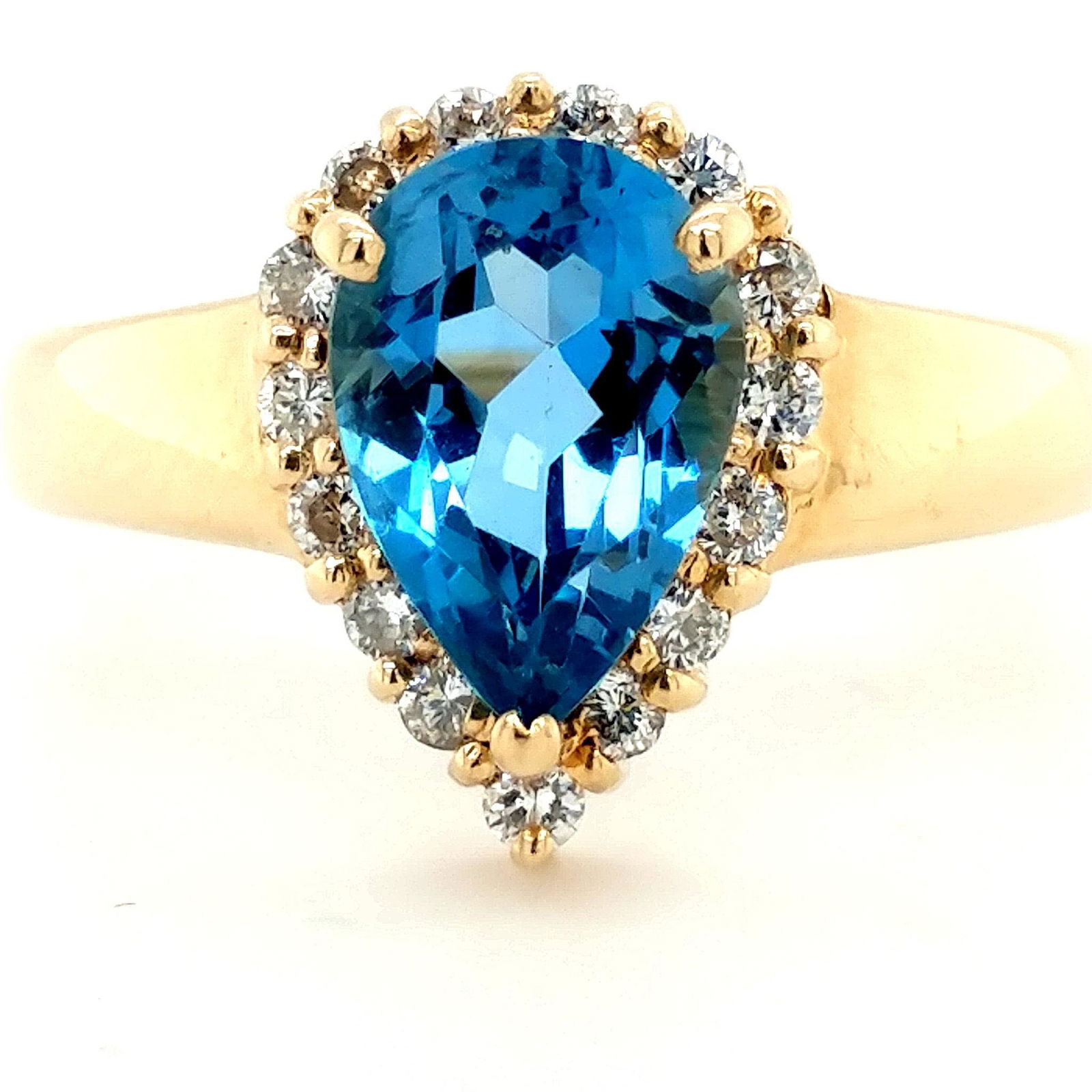 14K Yellow Gold Blue Topaz Diamond Halo Ring: This is a 14K Yellow Gold ring set with an approximately 3.9ct (10mmx7mm) pear-shaped Blue Topaz, surrounded with approximately .30ctw diamonds. The ring is a size 8.25 and weighs 4.6 grams. This is a