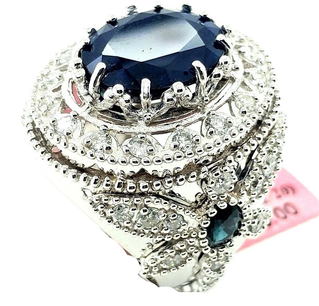 Certified 14K WG Sapphire & Diamond Dragonfly Ring: Certified and appraised 14KT white gold 11.6ct oval, faceted, natural sapphire ring surrounded by 2.44ctw round, brilliant-cut G/H, SI1/2 diamonds and dragonfly designs on both sides of the ring. The 