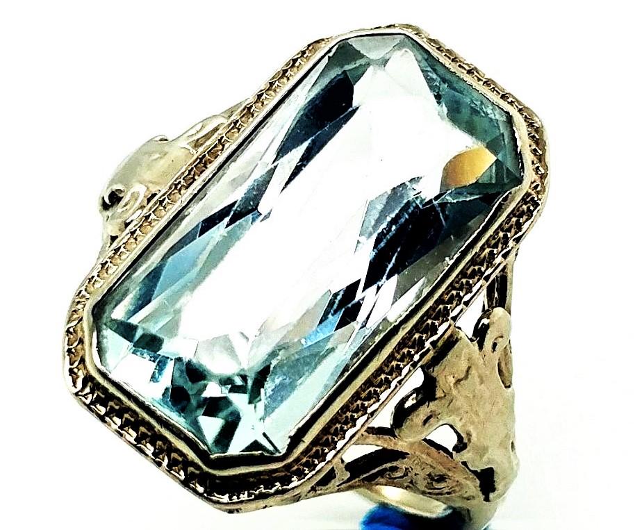 Edwardian Aquamarine 14k White Gold Ring: Stunning antique Edwardian 14k white ring set with a natural 16 X 8 Aquamarine gemstone. Its a size US 5 and weighs 3.6 grams. Some wear can be seen on the gemstone. It does not take away from this ra