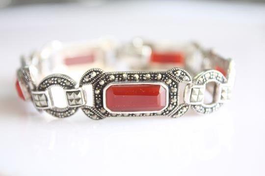 Marcasite Carnelian Art Deco Sterling Bracelet: Vintage Art Deco inspired sterling silver bracelet. Itâ€™s approximately 8 inches long and 1/2 inch wide. The bracelet is set with stunning long faceted Carnelian gemstones and round rose cut & s