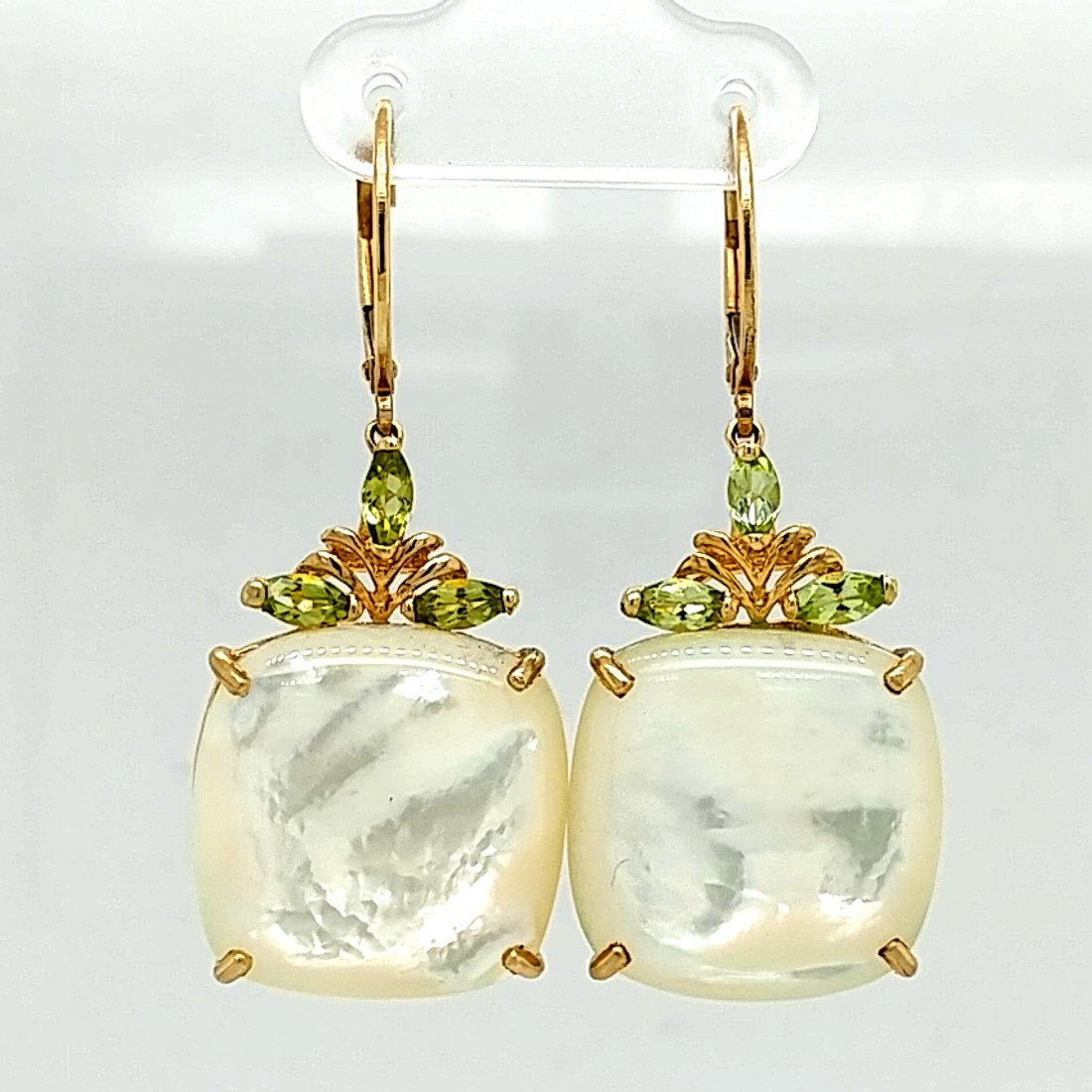 14K Yellow Gold Mother of Pearl & Peridot Earrings: This is a pair of 14 karat yellow gold mother of pearl and peridot dangling earrings. The mother of pearl are approximately 3/4" diameter and each are topped with three marquise peridot. The earrings 