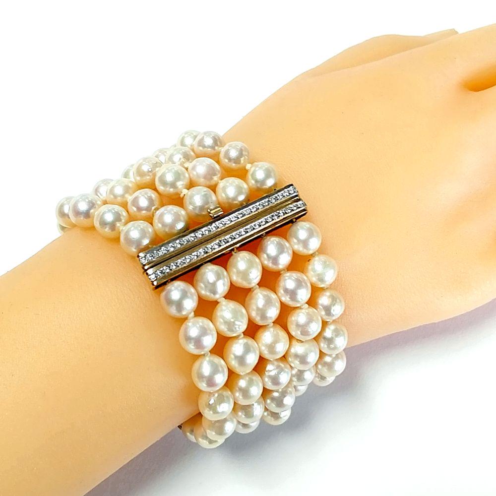 14K Yellow Gold Pearl and Diamond Bracelet: This is a 14kt yellow gold 5-strand pearl and diamond bracelet. The creamy white pearls are approximately 8mm and have a slight rose hue. The pearls are not perfectly round, but more baroque. There ar