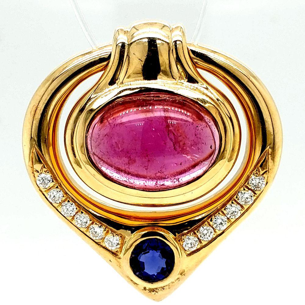Pink Tourmaline, Tanzanite & Diamond Slide14K: This is a 14 karat yellow gold tanzanite, pink tourmaline, and diamond slide pendant. The approximate 5 carat oval, cabochon pink tourmaline is bezel set and accented with an approximate .50 carat rou