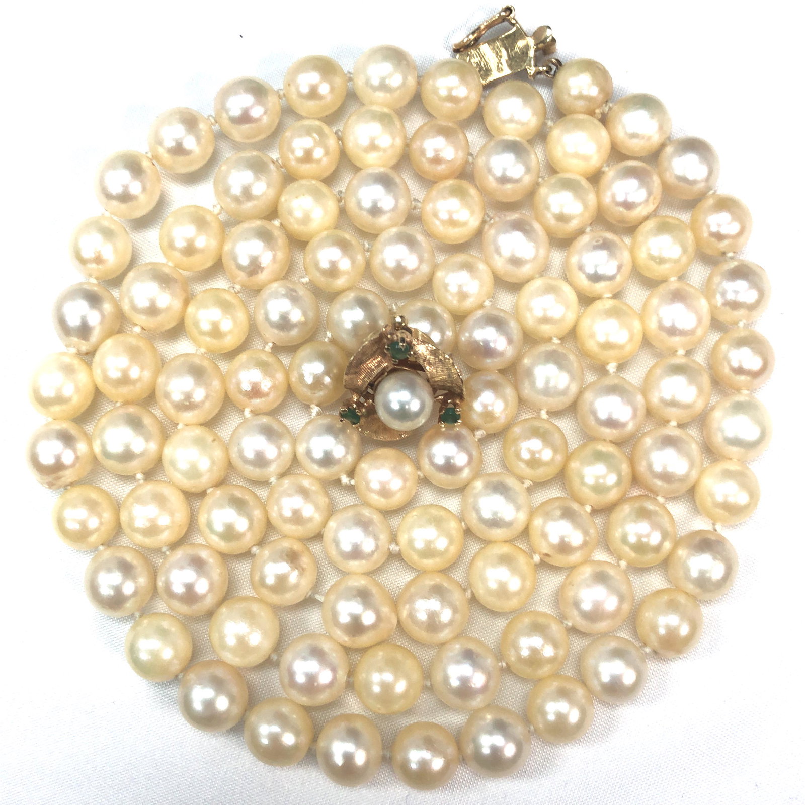 30" Cultured Pearl Strand w/14K and Emerald Clasp: This is a 30" strand of cultured pearls with a 14 karat yellow gold emerald and pearl clasp. The pearls are approximately 7.5 mm and have a creamy ivory to silvery rose color. The strand is approximat