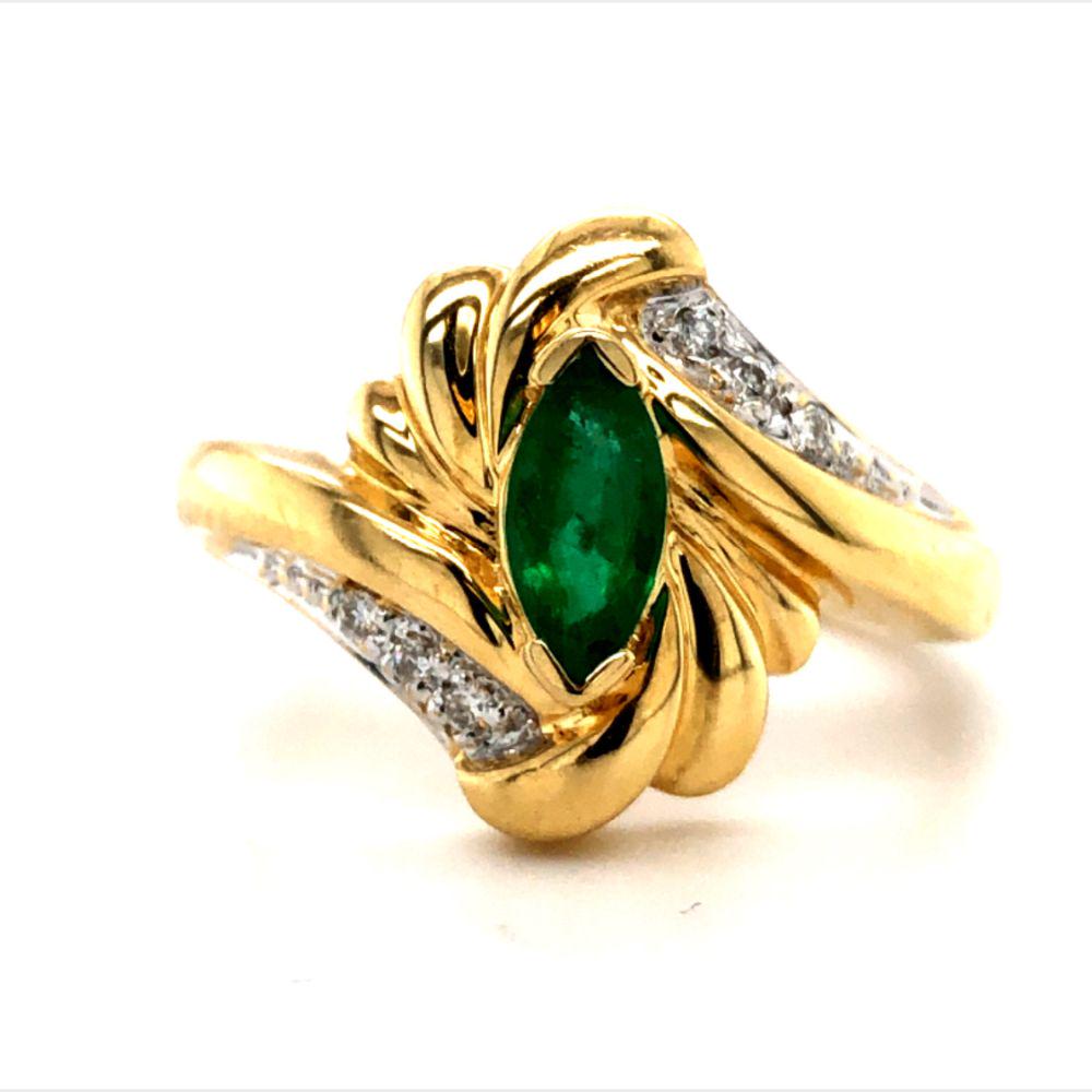Emerald and Diamond Ring 14K: This is a 14 karat yellow gold natural emerald and natural diamond ring. The approximate .30 carat marquise-cut emerald is set in a bypass style setting with diamond accent. The ring is US