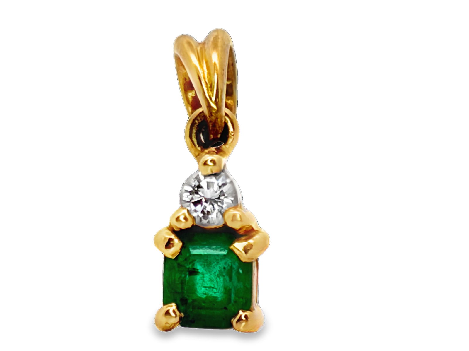18K Emerald & Diamond Pendant: ISL2293/74-EOY This refined drop pendant is expertly crafted in 18-karat two-tone gold, showcasing a beautiful vertical arrangement of two prized gemstones. The primary stone is a richly colored eme