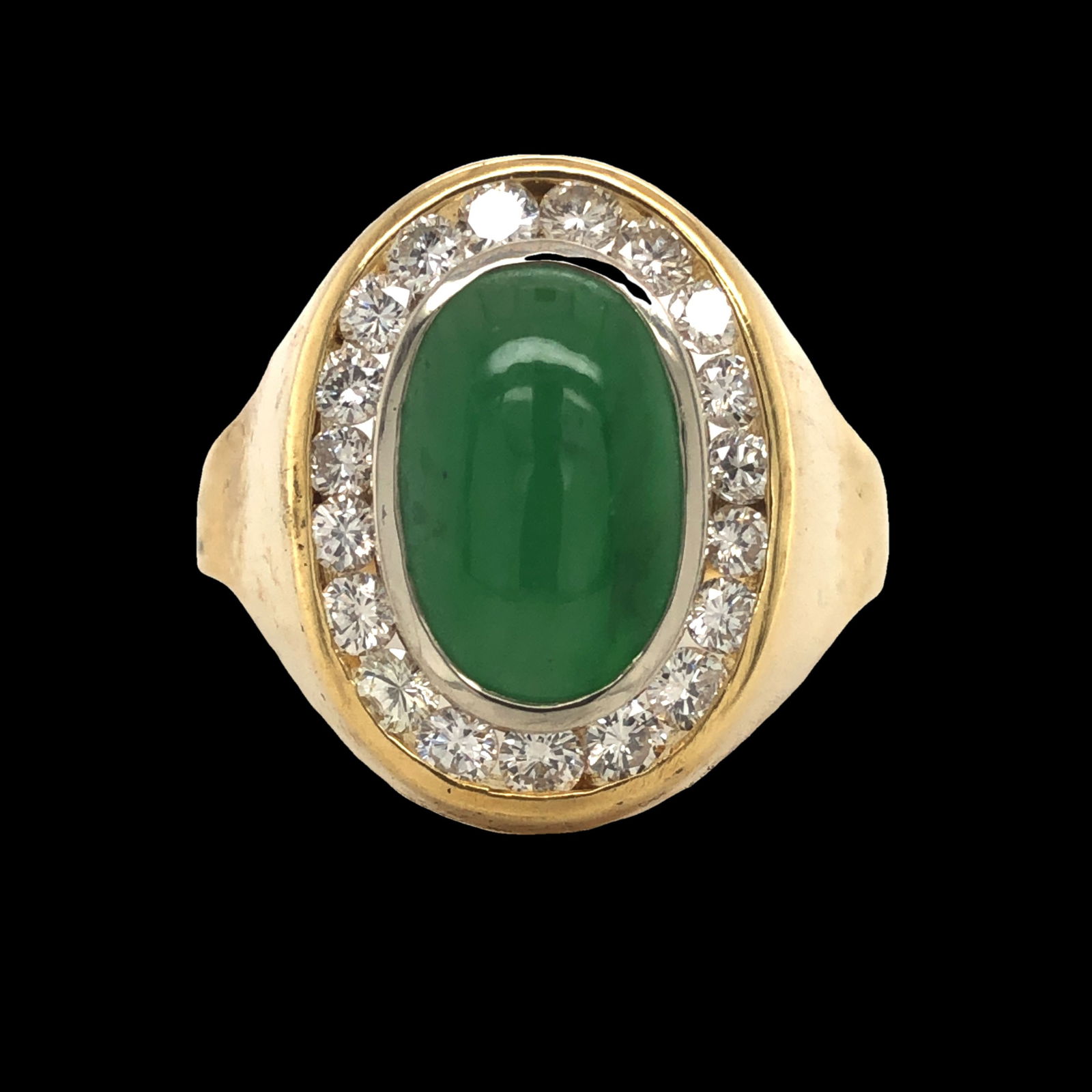 Jade and Diamond Ring: S/10.5-MOSS This impressive ring showcases a beautiful oval-shaped jade cabochon, radiating a rich green hue, set as its vibrant centerpiece. The jade is elegantly encircled by a halo of