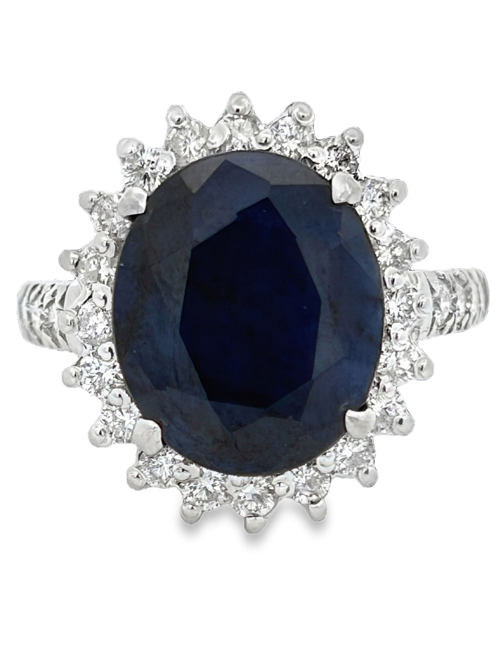 Blue Sapphire with Diamond Halo Ring: ISL2293/35-MKYS Captivate attention with this extraordinary ring, centered on a substantial oval-cut natural blue sapphire of a deep, velvety midnight hue. This magnificent centerpiece is