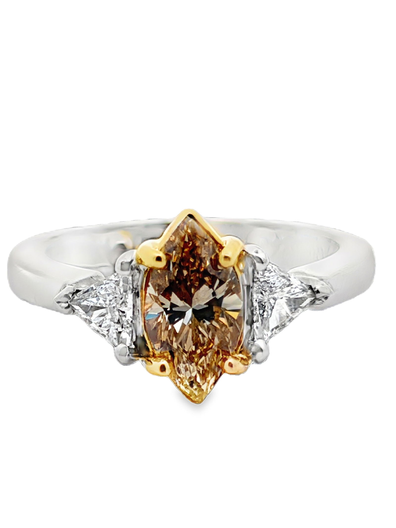 18K / Platinum Fancy Brown Diamond Ring: ISL2293/42-MLYS This is an elegant three-stone diamond ring crafted with mixed metals, utilizing 18K yellow gold and platinum. The striking centerpiece is a marquise-cut fancy