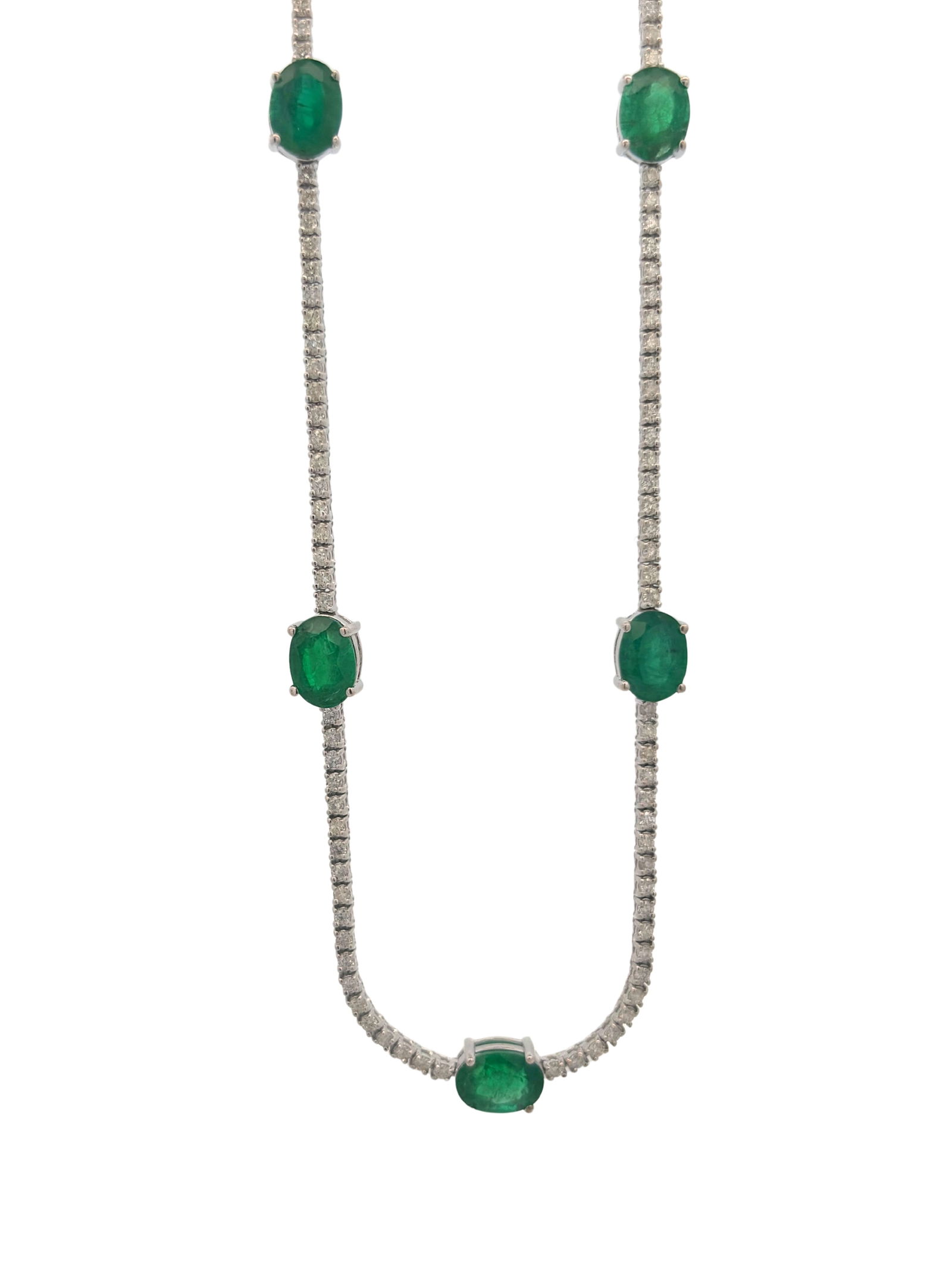 14K Emerald & Diamond Necklace: E7605/6-OLNT This striking 14k gold necklace features a vibrant emerald-cut emerald that radiates a deep, forest-green brilliance. The gemstone is securely held in a polished prong setting,