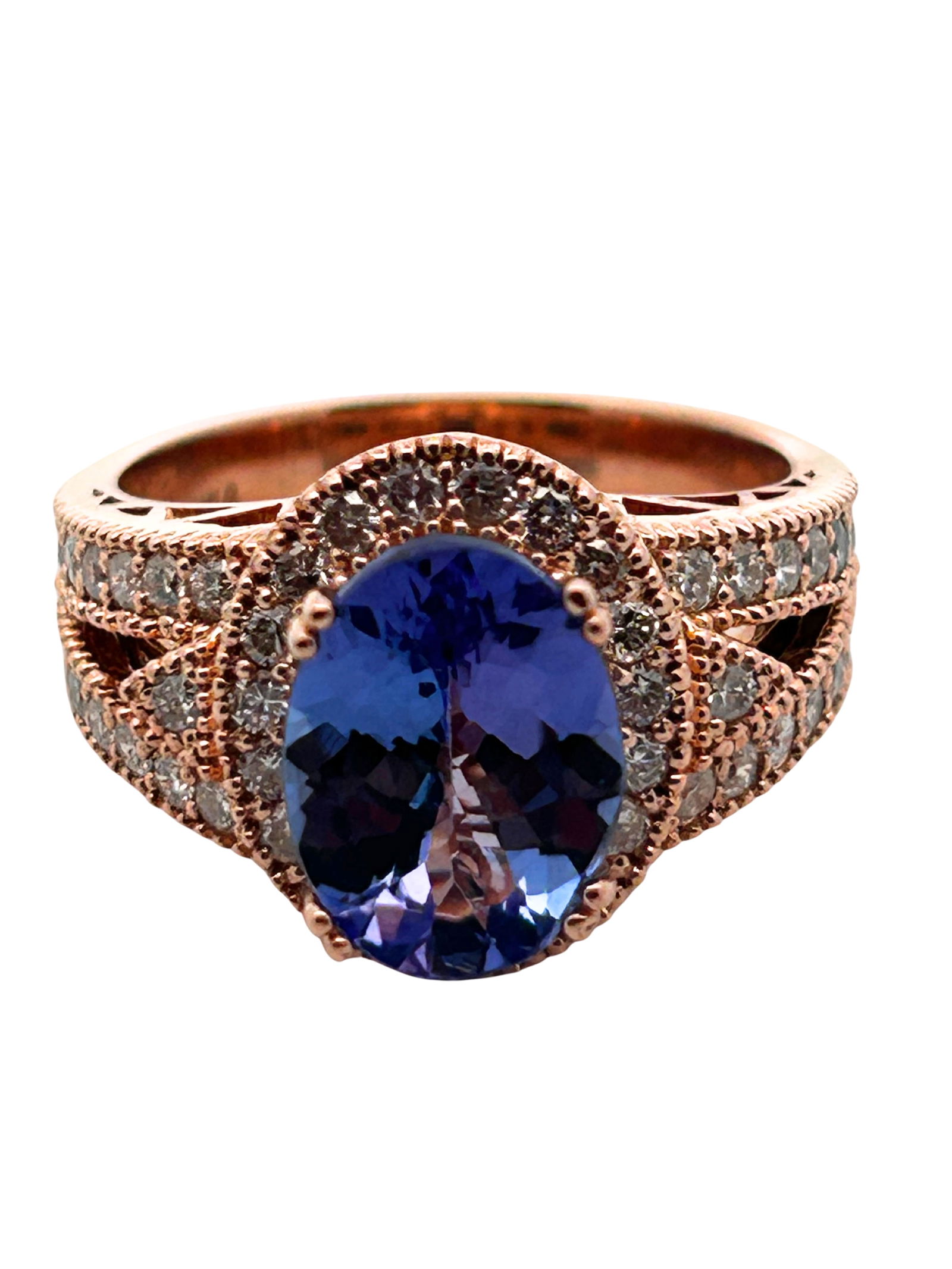 14K Tanzanite & Diamond Ring: S/7.83-MTSS This breathtaking 14K rose gold ring is a celebration of color and light. At its heart, a magnificent oval-cut tanzanite displays a rich violet-blue hue, a rare and sought-after