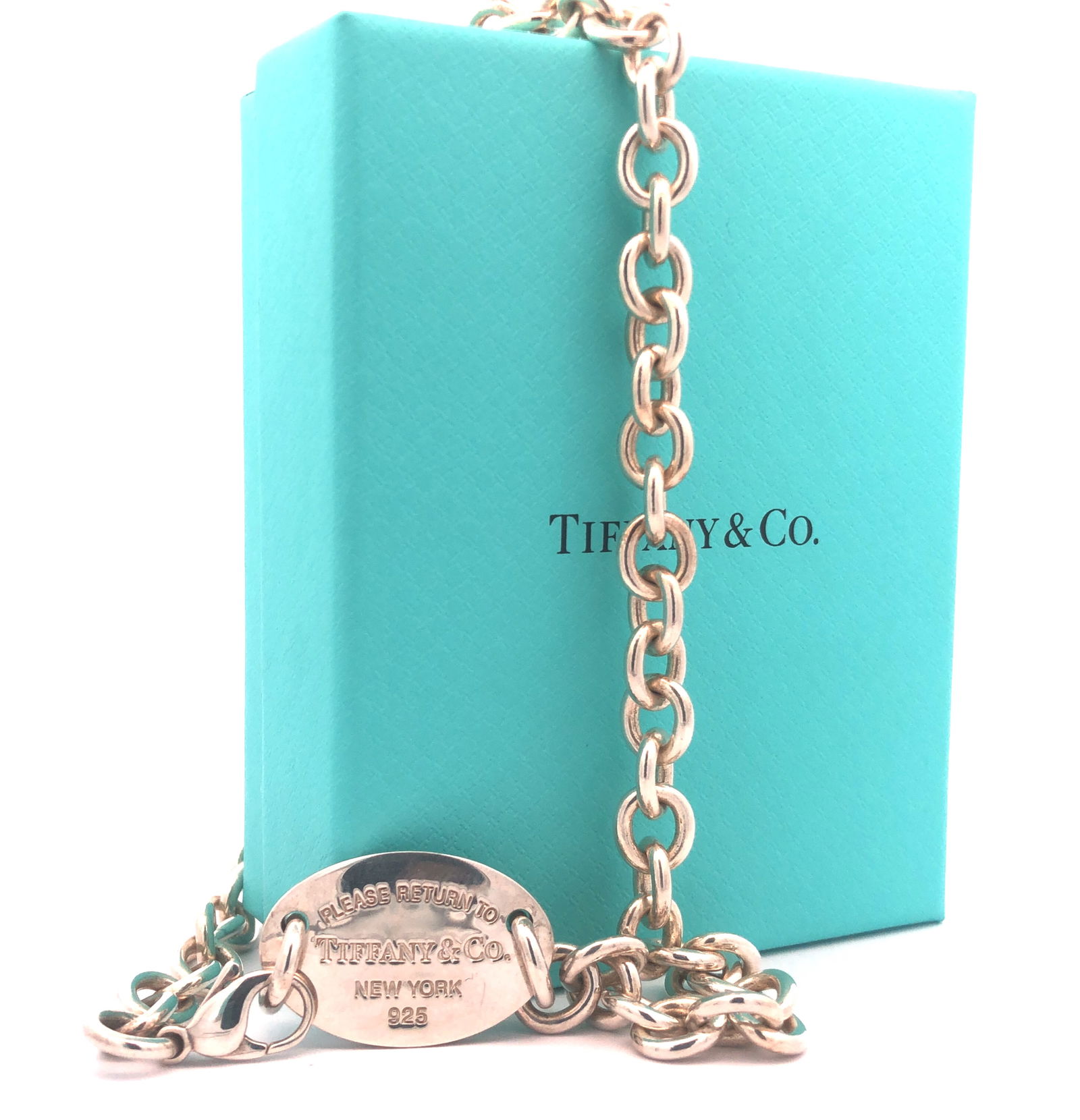 Return to Tiffany & Co. Oval Tag Necklace Choker: JS/51-LSS This iconic piece from the world-renowned design house of Tiffany & Co. is a testament to timeless elegance and minimalist style. The choker is crafted from high-quality sterling