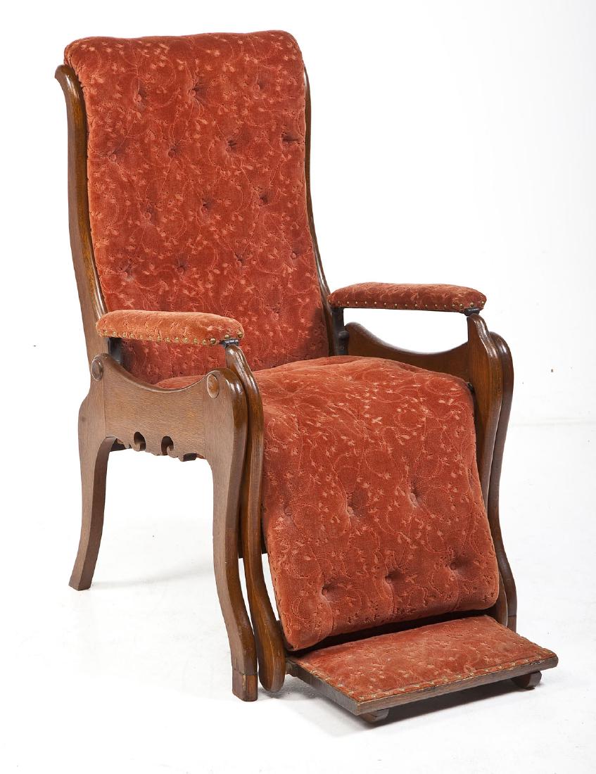 Victorian Reclining Dentist Chair: DESCRIPTION: Victorian reclining dentist chair with red upholstery and oak frame. MEASUREMENTS: 25" x 40" x 45" high. Open 25" x 71" by 45" high. CONDITION: Wear and fading to fabric most noticeable t