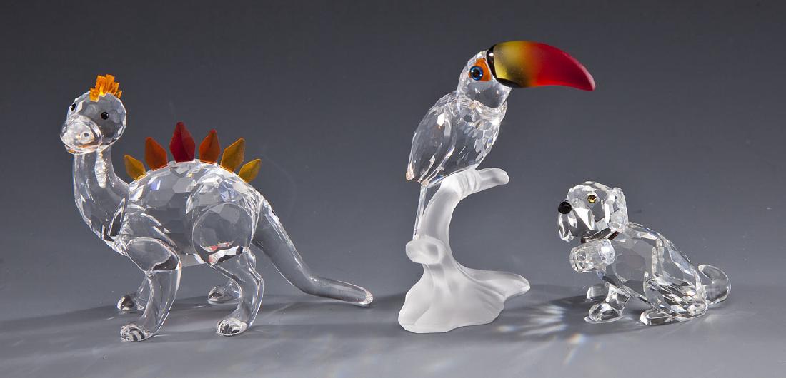 3 Swarovski Animals in OBs: DESCRIPTION: Three Swarovski animals. Includes: 1) 1-1/2" St. Bernard A7619 NR000 006. 2) 3-1/4" Toucan 7621 NR000 006. 3) 2-3/4" Dino A268204. Each with Swarovski mark to base. Each in original boxes